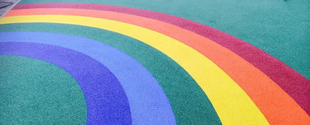 Rainbow playground markings on rubber play surfacing